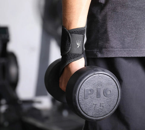 Person lifting dumbbell wearing Two Pack Wrist Compression Straps And Wrist Braces For Fitness And Weightlifting, Pain Relief