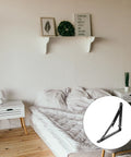 Heavy Duty Folding Black Iron Wall Brackets with solid support for tough durable shelves in a bedroom.