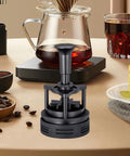 Killer Rotatable Espresso Coffee Distributor Stirrer Featuring Adjustable Height And Durable Aluminum Alloy Build on a counter next to coffee.