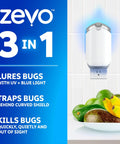 Plug In Bug Zapper For Straight Up Home Pest Control Killer Against Fruit Flies And Those Dang Gnats With UV Light and no mess adhesive cartridge on kitchen counter with fruits.