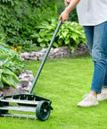 Person using Rolling Lawn Aerator With Fender And 18 Inch Spike Roller, 50 Inch Anti Slip Handle, Heavy Duty Manual Lawn Aerator