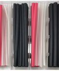 Organized assortment of Pro Grade Adhesive Lined Heat Shrink Tubing Kit For Auto And Marine Electrical Protection Includes Sizes Three Sixteenth Inch One Quarter Inch Three Eighth Inch In Red Clear And Black Flame Retardant 100 Piece Assortment Made In USA in storage box showcasing 100 red, black, clear tubes.