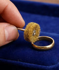Hand holding a 1.8 inch abrasive buffing wheel for metal polishing beside a ring, showcasing 100Pcs Abrasive Buffing Wheels Rotary Tool Polishing Accessories 1.8 Inch Doublelayer Surface Conditioning Set For Metal Deburring Repairs And Detail Work With 120To600 Grit Levels For Tough Jobs.