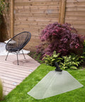 Windproof Dual Head Sprayer Nozzle Cover for farm and lawn irrigation, placed on green lawn, garden backdrop