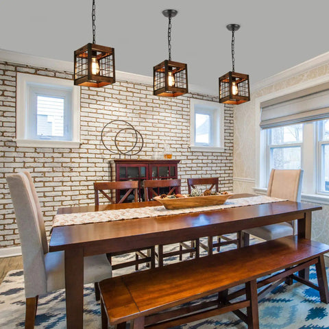 Dining room with square wood hanging lights casting warm light against brick wall and white framed windows