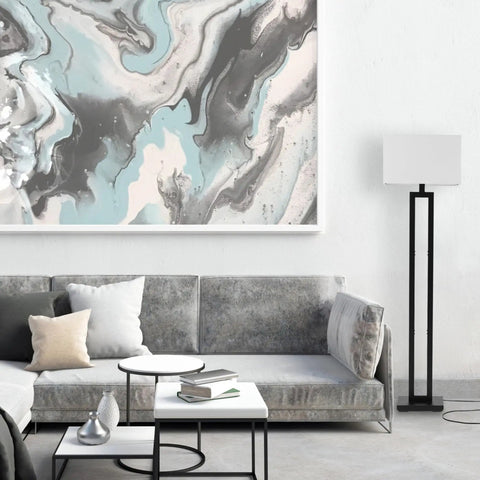 58 Inch Floor Lamp In Matte Black Finish With White Linen Rectangular Shade beside gray sofa in living room.