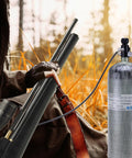 Person using Dual Gauge Paintball Fill Station Valve With 7/8-14UNF Thread 4500 Psi High Pressure Tank Charging System 20 Inch Non Regulated Hose PCP Air Gun Air Tank Valve in outdoor setting