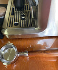 58Mm Bottomless Portafilter With Wooden Handle Compatible With Breville Espresso Machines BES900XL BES920XL BES980XL BES990BSS on a wooden surface.