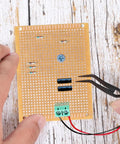 10 Pack 70mm x 90mm PCB Board Prototype Kit Universal Printed Circuit Board Copper Stripboard Perfboard For Electronics Experiments And DIY Soldering Projects Perfect For Makers And DIYers with components and hands holding tweezers.