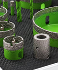 Close-up of Built Tough Diamond Tile Hole Saw Kit 16 Piece Core Drill Set with tri shank cutters in green, designed for masonry and tile.