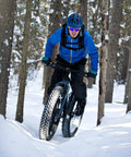 Cyclist riding through snowy forest using 2-Pack 26x4 Fat Bike Inner Tubes Built Tough Heavy Duty AV32mm 89/102-559 Schrader Valve.