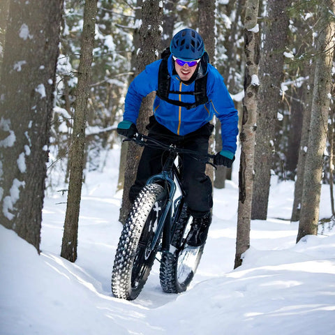 Cyclist riding through snowy forest using 2-Pack 26x4 Fat Bike Inner Tubes Built Tough Heavy Duty AV32mm 89/102-559 Schrader Valve.