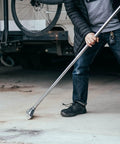 Person using Replacement 8 Inch Floor Razor Scraper Blades 5 Pack for heavy-duty garage flooring removal and demolition