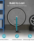 Pro Grade Wheel Truing Stand For Bikes in use, holding wheel upright in garage setting, high carbon steel, blue and black color.