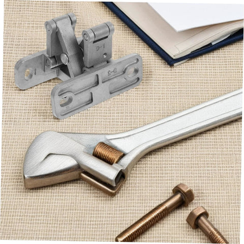 Close-up of concealed heavy-duty door hinge kit with mounting plates, bolts, and wrench