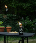Hunter Metal 64.5 Inch Torch Two Pack For Patio Backyard Lawn Decor Black Finish With Easy Installation on a table