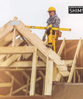 Construction worker using level on wooden framework, showcasing 8 Inch Wood Shims For Leveling Pro Pack 120 Count Wedges For Toilets Tables