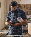 Man wearing Safety Bluetooth Earmuffs For Mowing And Power Tools With FM Radio NRR 29dB in workshop