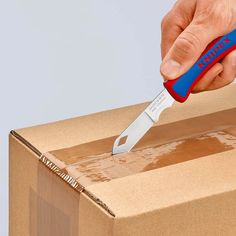 Using Everyday Carry Folding Knife With Ultra Sharp Solingen Blade on box, showcasing tough ergonomic handle and shock resistant plastic grip.