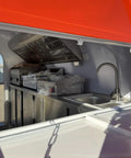 Fully Custom Mobile Food Trailer Concession Rig With Complete Commercial Kitchen For Festivals Pop Up Vendors Dessert Trucks And Drink Bars Built Tough And Ready To Roll interior with stainless steel appliances and sink.