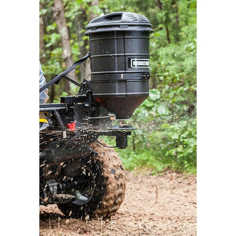 ATV Spreader With Manual Feed Gate For Seed Or Fertilizer, 100 Pound Hopper, Heavy Duty 12 Volt Motor in use on a forest trail