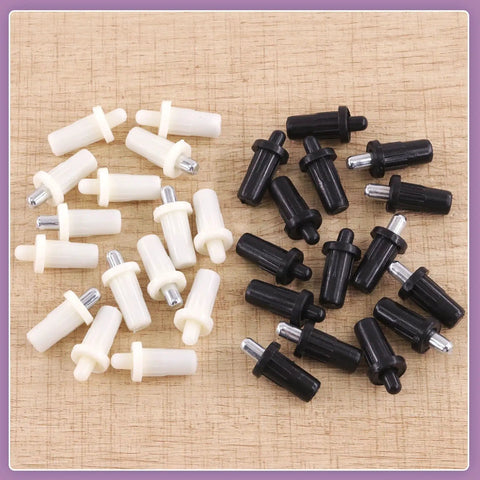 60 Piece 4 Sizes Spring Loaded Cabinet Door Repair Pins Set for shutters and doors, black and white pins on wood surface