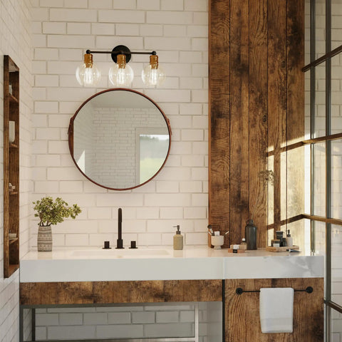 Coastal 3 Light Bath Vanity Light With Clear Glass Globes In Antique Bronze Finish installed above bathroom mirror