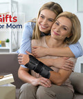 Mother wearing Wrist Brace For Carpal Tunnel And Night Time Pain Relief With Splints, hugged by daughter, gift box nearby.