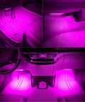 Under Dash Car LED Strip Light Kit 4 Pack 48 LEDs Waterproof Interior Neon Accent Strip For Cars DC 12V Pink Mood Lighting Easy To Install Hides Under Dash For Cozy Cabin Glow illuminating car footwells with pink light.