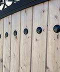 Top Shelf Matte Black Clavo Nails 50 Pack 1.5 Inch Decorative Studs on rustic wooden barn door for upholstery use.