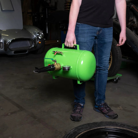 Person holding 5 Gallon Tire Bead Seater And Bead Blaster For 4 To 24.5 Inch Tires 150 PSI Capacity CE Certified Steel Tank