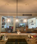 Dope Three Light Modern Industrial Farmhouse Kitchen Island Pendant Lighting with clear glass shades over kitchen counter