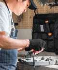 Hella Durable Black Nitrile Safety Gloves With Sick PyraGrip Texture For Superior Traction On Greasy Jobs in use while handling power tools.
