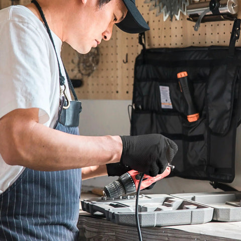 Hella Durable Black Nitrile Safety Gloves With Sick PyraGrip Texture For Superior Traction On Greasy Jobs in use while handling power tools.