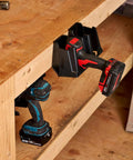 Universal Drill Holder And Power Tool Organizer Wall Mount Rack for Cordless Drills, installed under wooden bench with two drills.