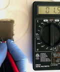 Conductive Paint Pen For Quick Circuit Repairs And EMF Shielding used with multimeter showing conductivity reading, precision work.