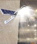 Outdoor Solar Security Flood Light With Remote And Dusk To Dawn Sensor Super Bright Led Yard Lighting Badass Weatherproof mounted on wall with rain.