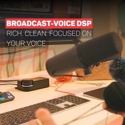 USB XLR Audio Interface For Creators With Built In DSP Mic Chain, on desk next to microphone, keyboard, and monitor