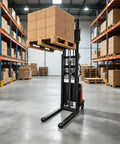 Serious 3300 Lb Warehouse Pallet Stacker With 95 Inch Lift Height, Powerful 1.6KW Motor And Smooth Walkie Operation For Busy Forklift Jobs lifting a pallet of boxes in a warehouse.
