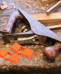 4 Piece Ratchet Woodworking Strap Clamp Blocks Set For Quick Fix Band Clamps shown next to a woodworking planer on a workbench
