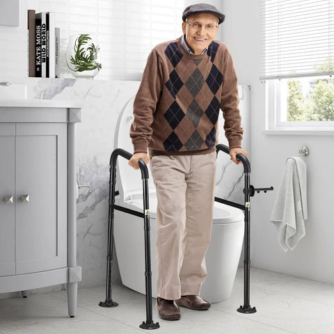Elderly man using Universal Toilet Safety Rail With Adjustable Height And Width, 4 Non Slip Suction Cups, Heavy Duty Grab Bar You Can Count On, 350 Lbs Load Capacity, Includes Paper Towel Rack, For Elderly And Handicap, Black, in bathroom
