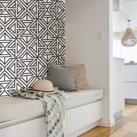 Room corner with Black And White Geometric Peel And Stick Wallpaper For DIY Projects Repositionable And Removable With No Residue Sticks To Smooth Surfaces Safe For Walls Modern Linear Pattern For Quick Accent Transforms on wall behind a cozy bench.