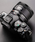 Canon EF To Micro Four Thirds Focal Reducer Booster Adapter 0.71x mounted on camera with 50mm lens for autofocus
