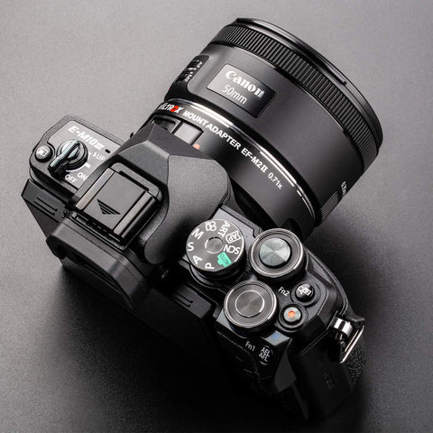 Canon EF To Micro Four Thirds Focal Reducer Booster Adapter 0.71x mounted on camera with 50mm lens for autofocus
