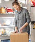 Person sealing a box with EZ Start Packing Tape With One Handed Dispenser 1.88 Inch By 55.5 Yard Crystal Clear Tape Roll.