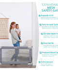 Extra Wide Mesh Baby Gate For Doorways And Hallways Expands From 27.5 To 50 Inches 28 Inches Tall Pressure Mounted For Toddlers And Pets Includes Rubber Bumpers Gray in use, blocking a doorway, shown with a parent and child for scale.