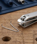 Quick Rebound Stainless Steel Torsion Springs For Nippers And Pruning Shears. Durable Pedicure Tool Replacement Hardware That Slides In Effortlessly For Smooth Clipping Action Every Time. Get Your Beauty Instruments Back To Crisp Working Condition With. stainless steel spring beside nail nipper on wood