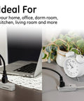 Three Outlet Flat Extension Cord With 15 Foot Reach Grounded 3 Prong Power Strip For Home Office And Entertainment Centers 16 Gauge Indoor UL Listed With Flat Plug Gray Perfect For Desks And Media Setups In Apartments Or Dorms shown on a desk and next to a clock.