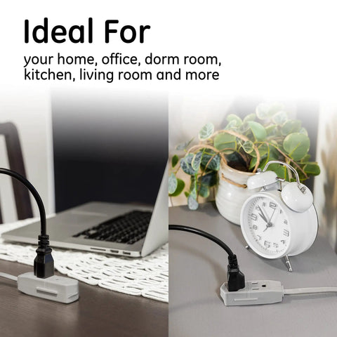 Three Outlet Flat Extension Cord With 15 Foot Reach Grounded 3 Prong Power Strip For Home Office And Entertainment Centers 16 Gauge Indoor UL Listed With Flat Plug Gray Perfect For Desks And Media Setups In Apartments Or Dorms shown on a desk and next to a clock.