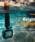 Bright orange floating selfie stick with Bluetooth remote, submerged in water, ideal for GoPro Hero underwater shots.